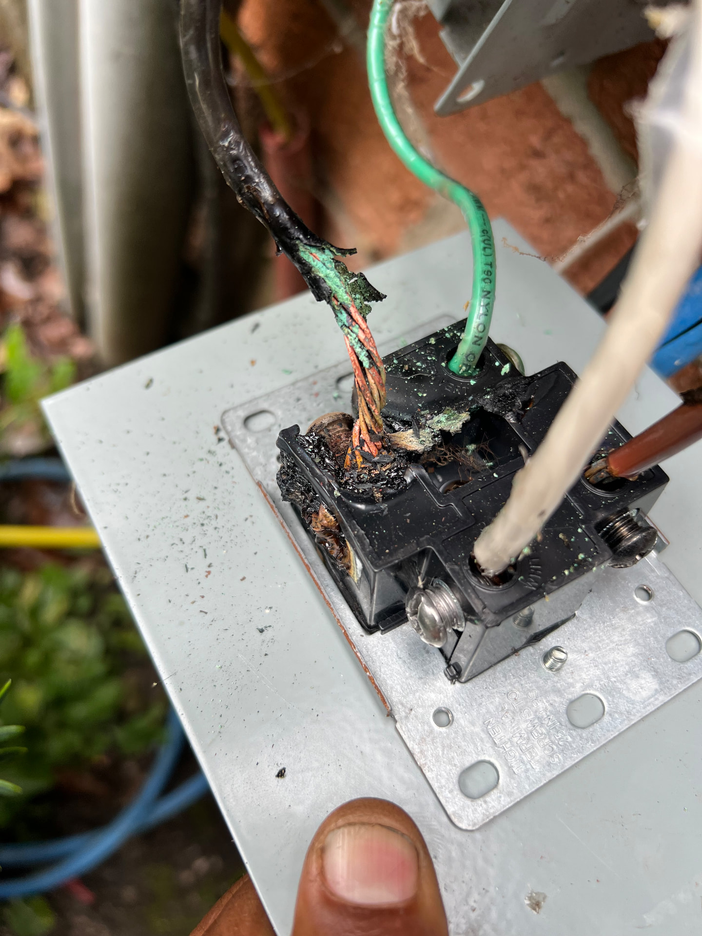 Burned and corroded range receptacle removed from a Baltimore garage after being used to charge an EV